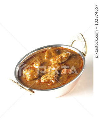 Spicy Indian curry with chicken shot on white background Spicy Indian curry with chicken shot on white background 102874657