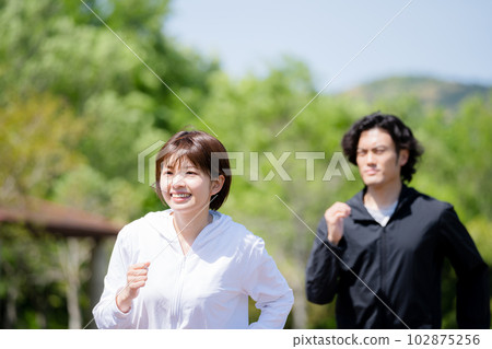 Young couple running in the park Young couple running in the park 102875256