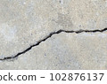 Cracks on the surface of the road or wall 102876137