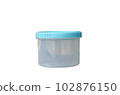 Small transparent round plastic container and blue cap isolated on white background 102876150
