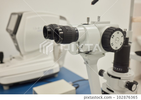 Slit lamp. Biomicroscope. Binoculars. Ophthalmic equipment.. Close up, selective focus. Health care concept. Slit lamp. Biomicroscope. Binoculars. Ophthalmic equipment.. Close up, selective focus. Health care concept. 102876365