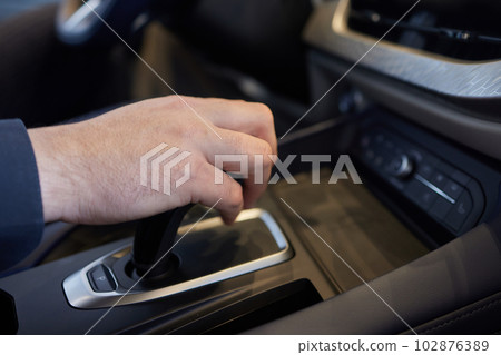 Selector automatic transmission with leather in the interior of a modern expensive car. The background is blurred. Black and brown leather car. 102876389