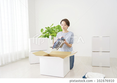 Woman packing for moving 102876910