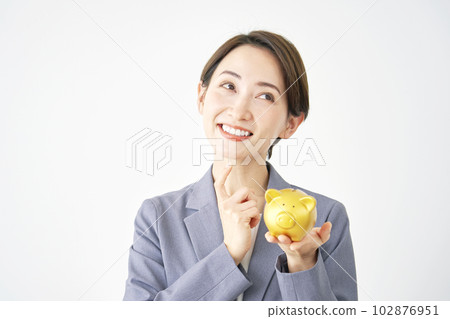 Business woman imagining holding a piggy bank White background Business woman imagining holding a piggy bank White background 102876951