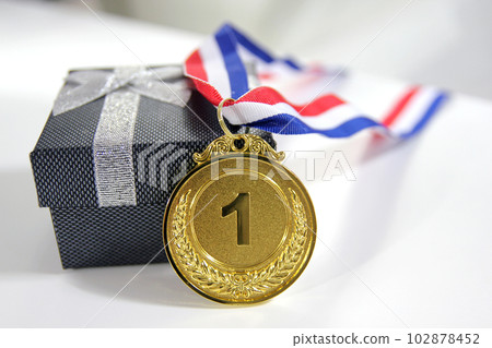 Gold medal 1 place with a ribbon on a light gray background, the concept of victory or success 102878452
