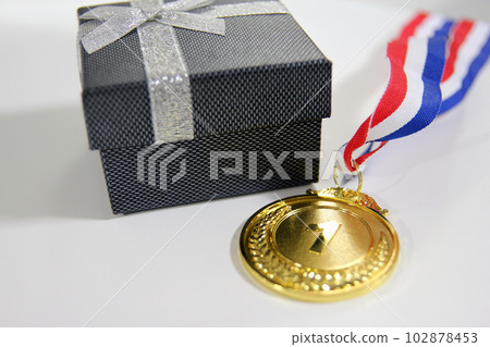Gold medal 1 place with a ribbon on a light gray background, the concept of victory or success 102878453