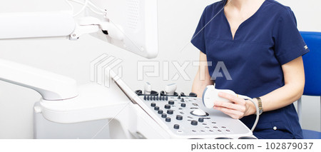 Female doctor sitting in office in a hospital doing ultrasound scanning diagnostic Female doctor sitting in office in a hospital doing ultrasound scanning diagnostic 102879037