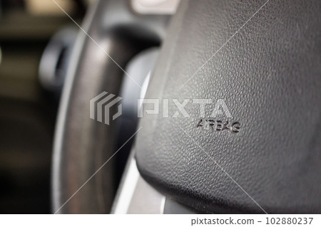 Safety airbag sign on car steering wheel 102880237