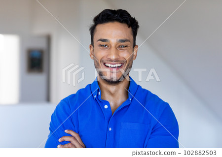 Portrait of happy biracial man looking at camera and smiling 102882503