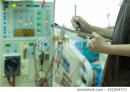 The specialist aThe specialist are checking continuous renal replacement therapy equipment and inre checking continuous renal replacement therapy equipment and injection pump and hemodialysis machine. The specialist aThe specialist are checking continuous renal replacement therapy equipment and inre checking continuous renal replacement therapy equipment and injection pump and hemodialysis machine. 102884757