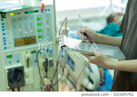 The specialist aThe specialist are checking continuous renal replacement therapy equipment and inre checking continuous renal replacement therapy equipment and injection pump and hemodialysis machine. The specialist aThe specialist are checking continuous renal replacement therapy equipment and inre checking continuous renal replacement therapy equipment and injection pump and hemodialysis machine. 102884762