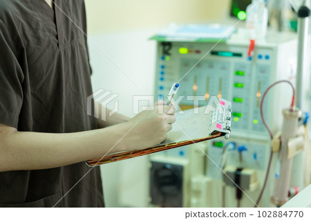 The specialist aThe specialist are checking continuous renal replacement therapy equipment and inre checking continuous renal replacement therapy equipment and injection pump and hemodialysis machine. The specialist aThe specialist are checking continuous renal replacement therapy equipment and inre checking continuous renal replacement therapy equipment and injection pump and hemodialysis machine. 102884770