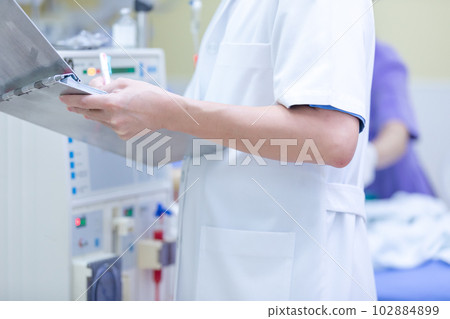 The specialist are checking continuous renal replacement therapy equipment and injection pump and hemodialysis machine. The specialist are checking continuous renal replacement therapy equipment and injection pump and hemodialysis machine. 102884899