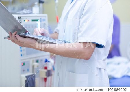 The specialist are checking continuous renal replacement therapy equipment and injection pump and hemodialysis machine. 102884902