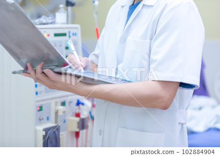 The specialist are checking continuous renal replacement therapy equipment and injection pump and hemodialysis machine. The specialist are checking continuous renal replacement therapy equipment and injection pump and hemodialysis machine. 102884904
