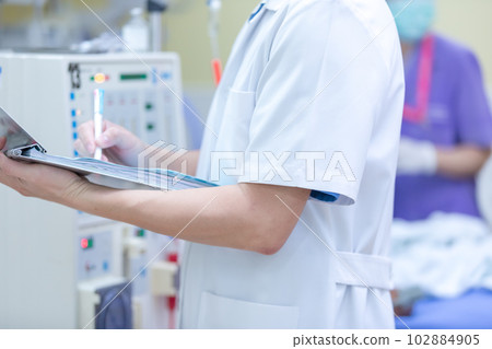 The specialist are checking continuous renal replacement therapy equipment and injection pump and hemodialysis machine. 102884905