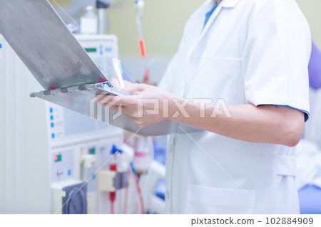 The specialist are checking continuous renal replacement therapy equipment and injection pump and hemodialysis machine. 102884909