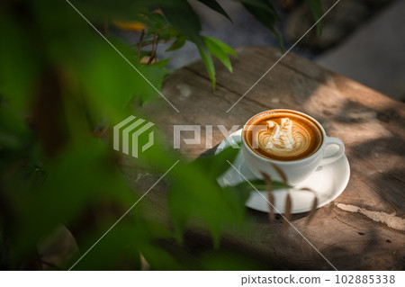 Background Coffee cup and beans on old kitchen table. Background Coffee cup and beans on old kitchen table. 102885338