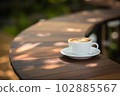 Background Coffee cup and beans on old kitchen table.  102885567