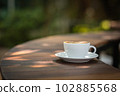Background Coffee cup and beans on old kitchen table.  102885568
