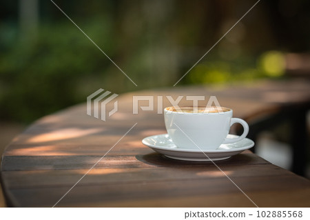 Background Coffee cup and beans on old kitchen table.  102885568