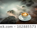 Background Coffee cup and beans on old kitchen table.  102885573