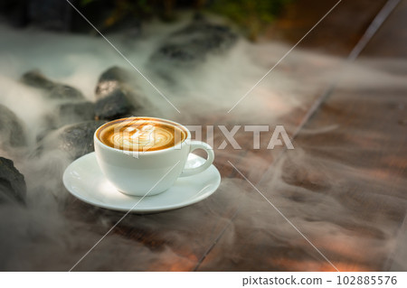Background Coffee cup and beans on old kitchen table.  102885576