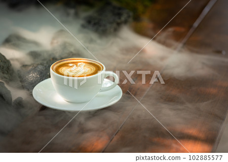 Background Coffee cup and beans on old kitchen table.  102885577