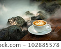Background Coffee cup and beans on old kitchen table.  102885578