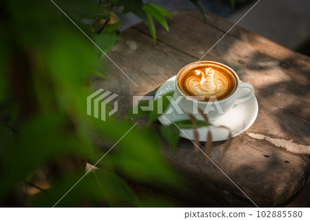 Background Coffee cup and beans on old kitchen table.  102885580