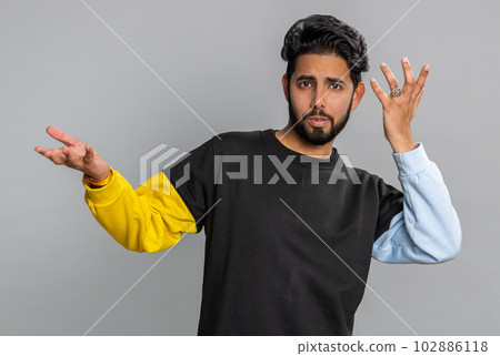Puzzled clueless uncertain man raising hands in helpless, embarrassed confused by difficult question Puzzled clueless uncertain man raising hands in helpless, embarrassed confused by difficult question 102886118