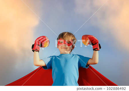 Superhero child against summer blue sky Superhero child against summer blue sky 102886492