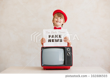 Newsboy shouting against grunge wall background. Boy selling fake news Newsboy shouting against grunge wall background. Boy selling fake news 102886503