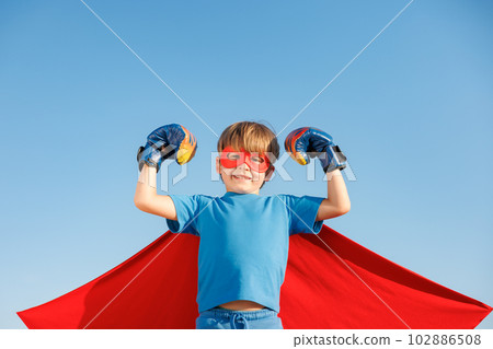 Superhero child against summer blue sky Superhero child against summer blue sky 102886508