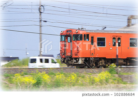 A vermilion diesel train bound for Izumo City running on the Sanin Main Line in the early afternoon (illustration style) A vermilion diesel train bound for Izumo City running on the Sanin Main Line in the early afternoon (illustration style) 102886684