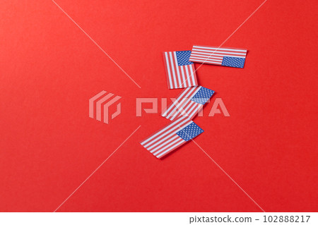 High angle view of four flags of united states of america with copy space on red background 102888217