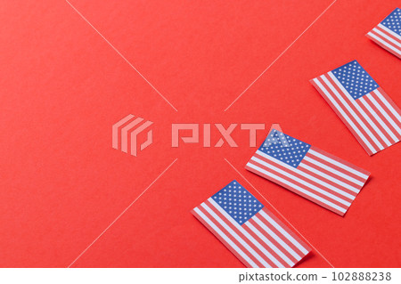 High angle view of four flags of united states of america with copy space on red background High angle view of four flags of united states of america with copy space on red background 102888238