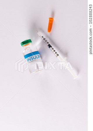Insulin vial and uncapped syringe on white background with copy space 102888243