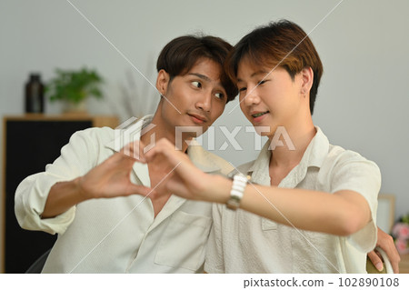 Affectionate same sex male couple making heart with their hands. LGBT, love and lifestyle relationship concept 102890108