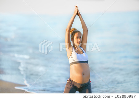 Pregnant woman doing yoga on the beach. Soft - Stock Photo [102890987] -  PIXTA