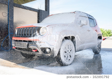 Car wash with soap. Car cleaning with high pressure water and foam 102891792