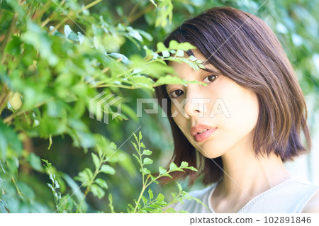 young woman among plants young woman among plants 102891846