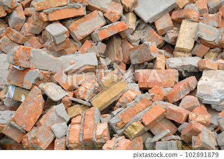 A pile of red broken bricks. Brick background A pile of red broken bricks. Brick background 102891879