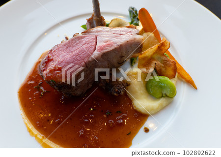 A dish of lamb served on a white plate 102892622