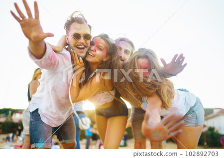 Teenagers Friends have fun at the holi festival. Beach Party. Celebrating traditional indian spring holiday. Teenagers Friends have fun at the holi festival. Beach Party. Celebrating traditional indian spring holiday. 102892703