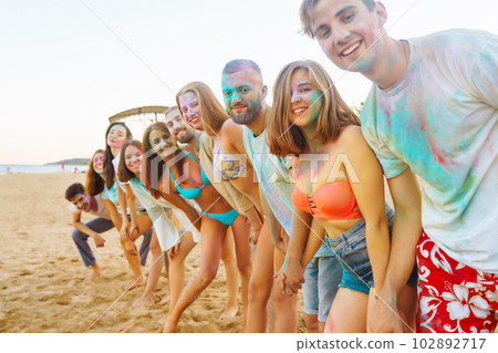 A group of friends have fun, dance at the holi festival. Celebrating traditional indian spring holiday. Friendship. A group of friends have fun, dance at the holi festival. Celebrating traditional indian spring holiday. Friendship. 102892717