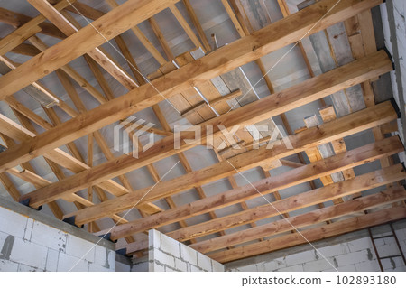 New construction of the house. Construction with wooden roof, pillar and frame beams. 102893180