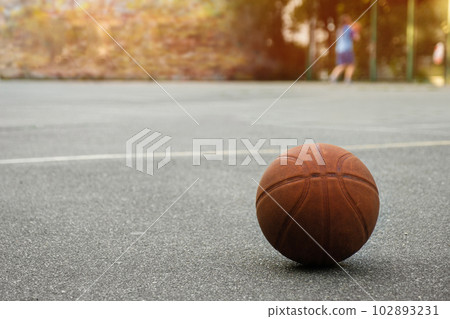 Basketball ball on the outdoor sports field on a sunny day. 102893231