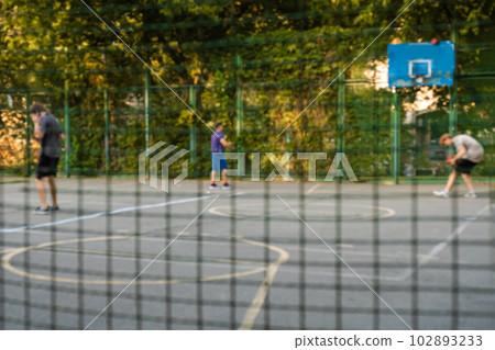 Blurred background of sports ground and people playing basketball 102893233