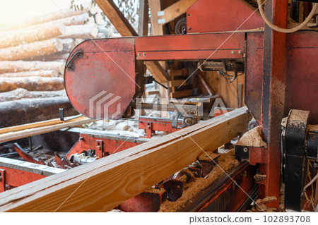 Processing wooden boards on a sawmill. Sawing and drying of wood. Woodworking industry 102893708